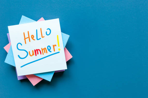 Hello Summer - inscription of many colored letters at notes on blue background. First summer day, Calendar concept. With copy space for text