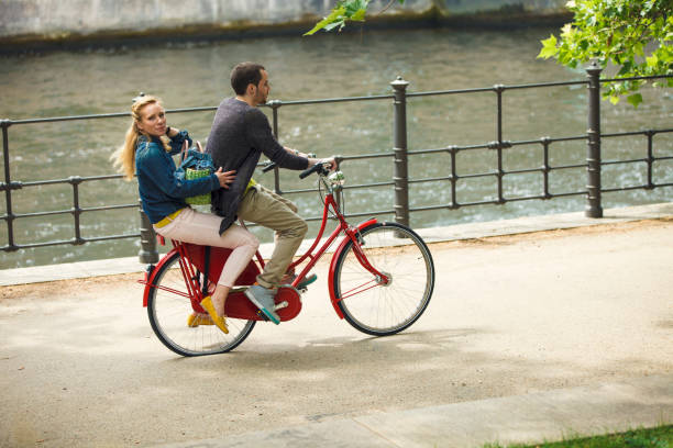 istock Couple Riding Together Bicycle In City 962379110