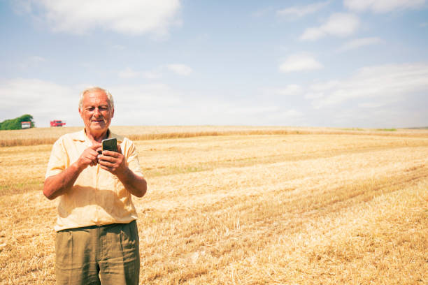 istock Farmer on a field with phone 962379366