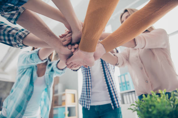 istock Agreement, achievement, handshake motivation connection concept. Cropped bottom view low angle close up portrait of business people's student's palms putting on top of each other, fist 962382892