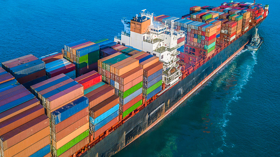 Aerial view of Cargo Ship Vessel in transit. Freight ship approaching to port. import export logistic and export products worldwide