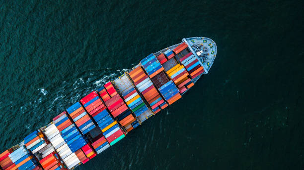 Cargo ship in import export and business logistic, Logistic and transportation of International Container Cargo ship in the open sea, Aerial shot from drone. Cargo ship in import export and business logistic, Logistic and transportation of International Container Cargo ship in the open sea, Aerial shot from drone, Thailand. maritime container stock pictures, royalty-free photos & images