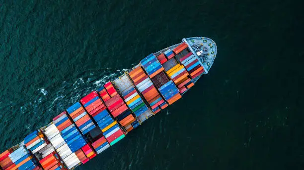 Cargo ship in import export and business logistic, Logistic and transportation of International Container Cargo ship in the open sea, Aerial shot from drone, Thailand.