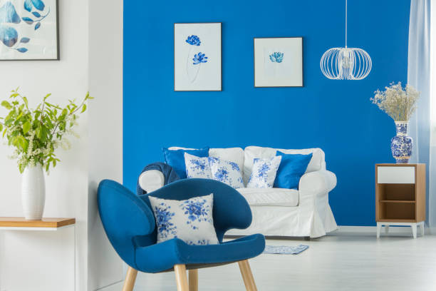 istock Blue armchair standing by white wall 962387834