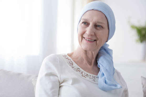 Happy woman in cancer headscarf Portrait of a happy, elderly woman in a headscarf for cancer patients, recovering from illness one senior woman only stock pictures, royalty-free photos & images