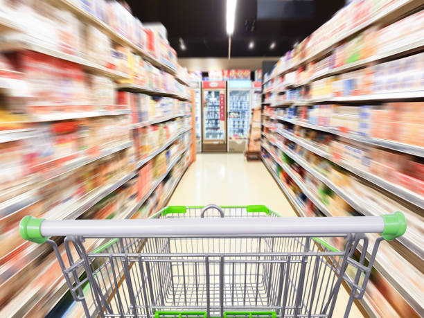 istock Supermarket aisle motion blur with empty shopping cart 962388050