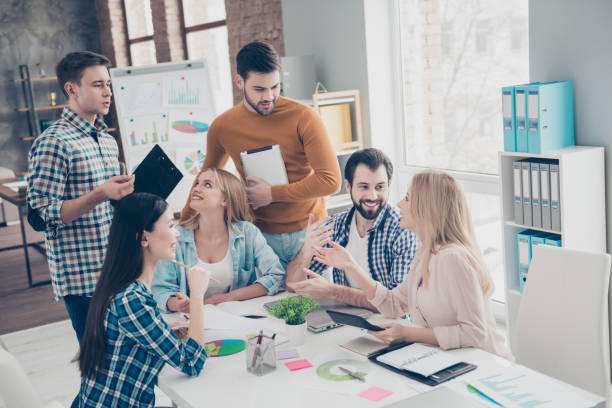 istock Attractive stylish confident cheerful positive beautiful handsome financiers having training seminar discussing new material, plan expressing opinions, view, mind in modern workplace 962391020
