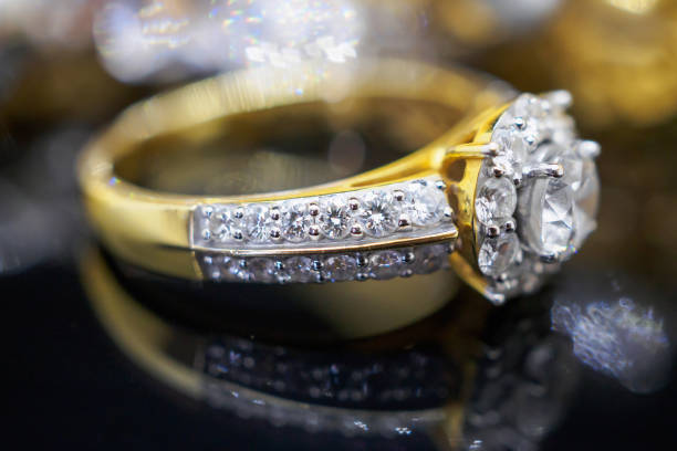 istock Luxury gold Jewelry diamond rings with reflection on black background 962400446