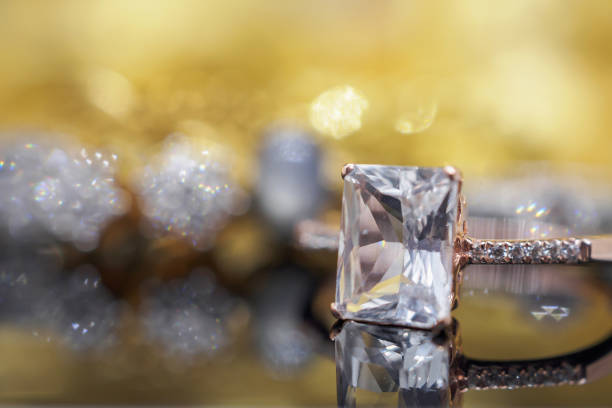 istock Luxury Jewelry diamond and pink topaz ring with reflection on black background 962400450