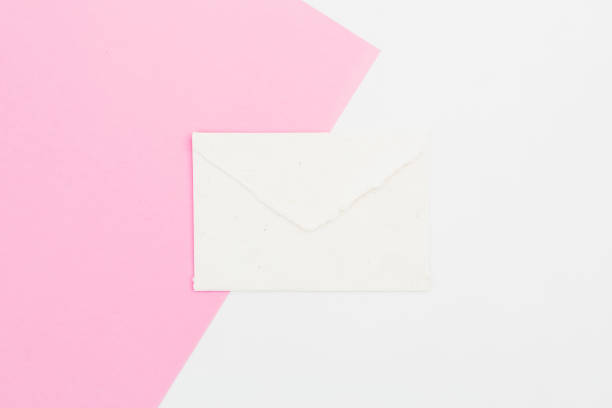 istock Paper vintage envelope on white and pink background. Flat lay. Top view 962409052