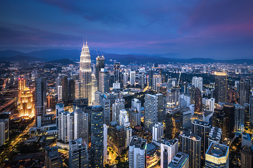 Aerial view of Kuala Lumpur skyline at dusk.
