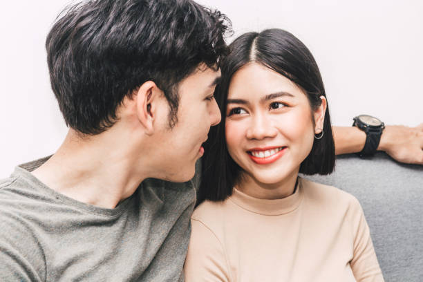 istock Happy couple sitting on sofa at home 962416610