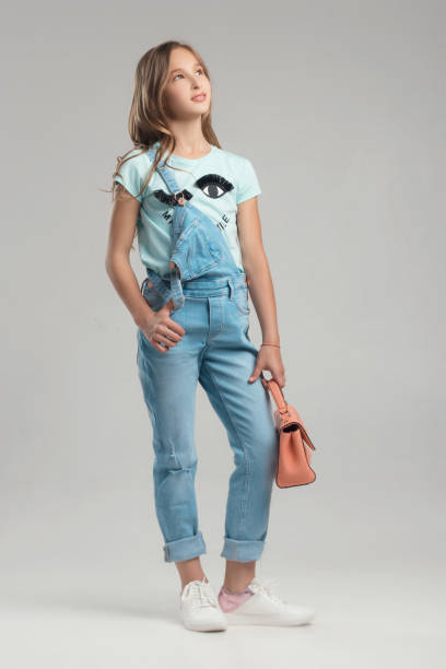 istock child in the Studio posing in fashionable clothes 962417542