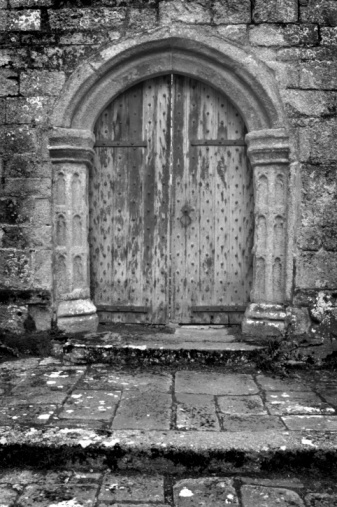 ancient medieval wooden door gate in stone and brick wall