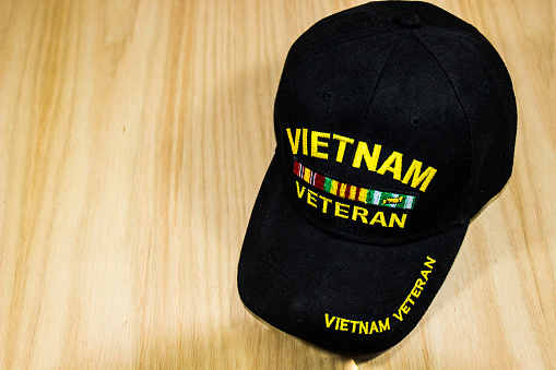 Vietnam Veteran Hat On Light Wood Background