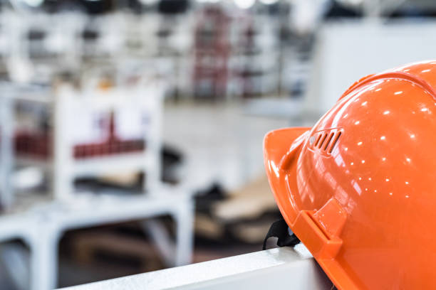 istock Safety helmet against industrial background 962425824