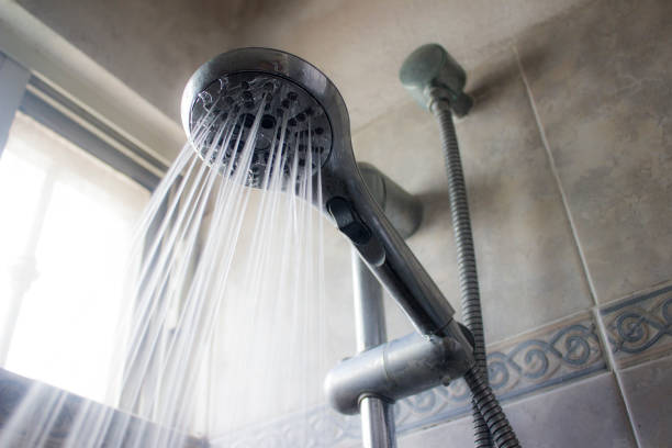 istock A shower head and a water stream pouring from it in a spray pattern. 962429322