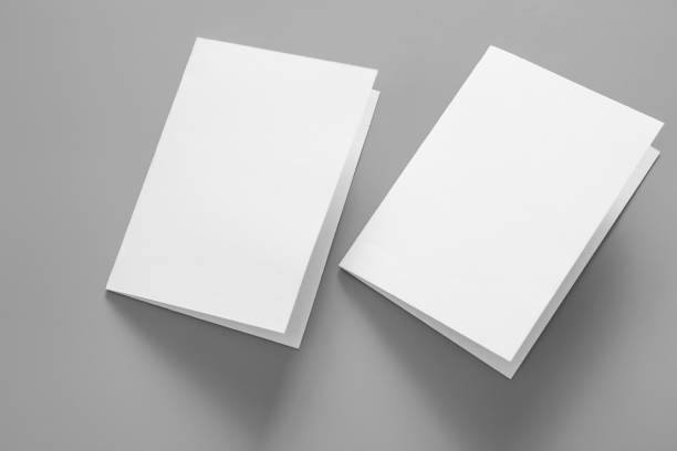 istock Blank portrait mock-up paper. brochure magazine isolated on grey, changeable background / white paper isolated on grey 962434208