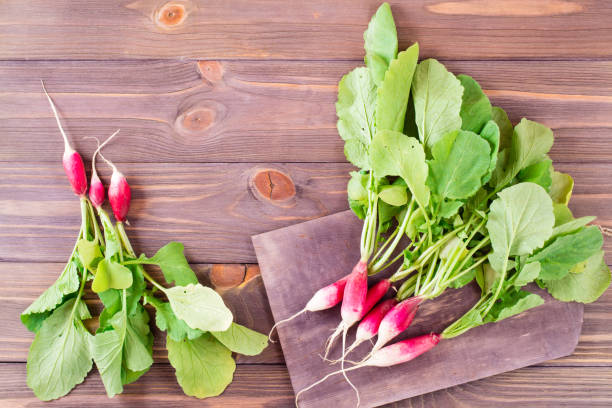 istock Fresh ripe washed radish on a cutting board on a wooden table 962434860