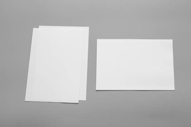 istock Blank portrait mock-up paper. brochure magazine isolated on grey, changeable background / white paper isolated on grey 962435230