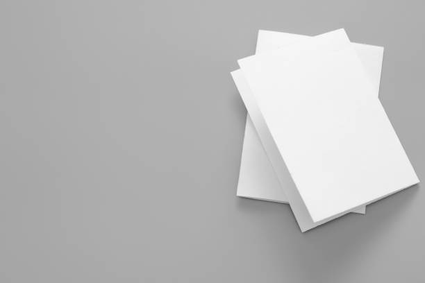 istock Blank portrait mock-up paper. brochure magazine isolated on grey, changeable background / white paper isolated on grey 962435414
