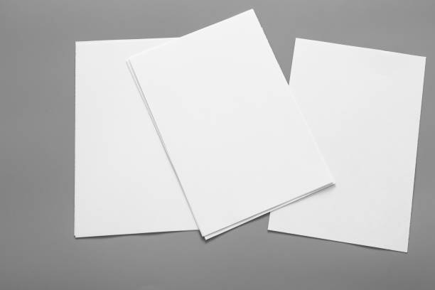 istock Blank portrait mock-up paper. brochure magazine isolated on grey, changeable background / white paper isolated on grey 962436382