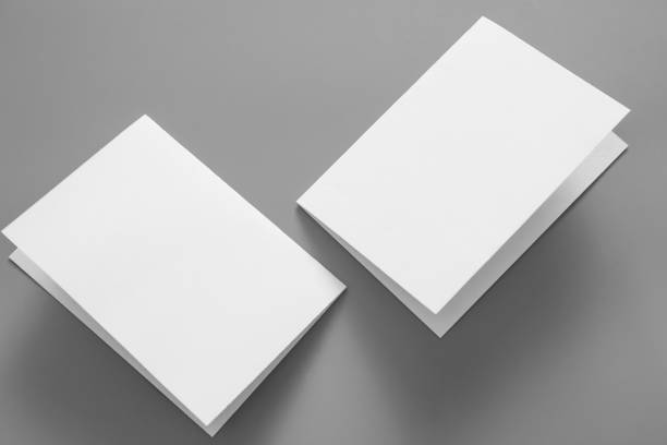 istock Blank portrait mock-up paper. brochure magazine isolated on grey, changeable background / white paper isolated on grey 962436914