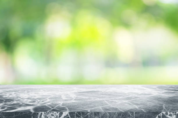 istock Gray marble stone counter top or table on backdrop blurred nature background / for display or montage your products / empty grey marble background concept. 962439746
