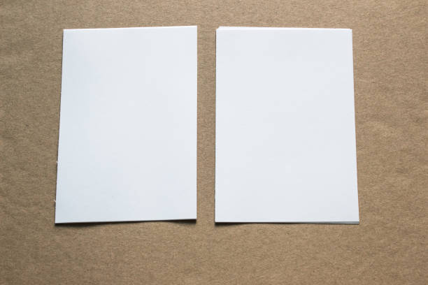 istock Blank portrait mock-up paper. brochure magazine isolated on grey, changeable background / white paper isolated on grey 962440174