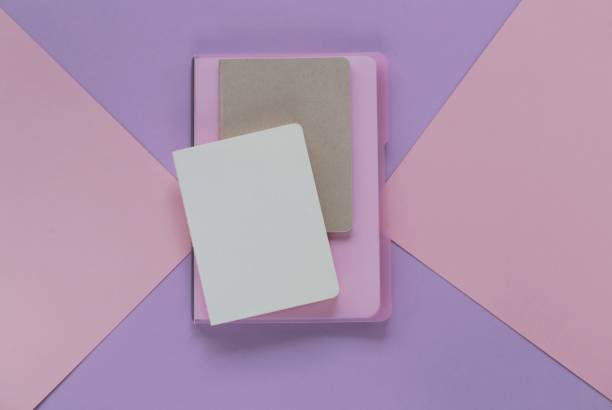 istock notebook on trend lilac pink graphic background. empty diaries in trendy pastel tones. flat lay in pastel colors. top view, copy space 962445694