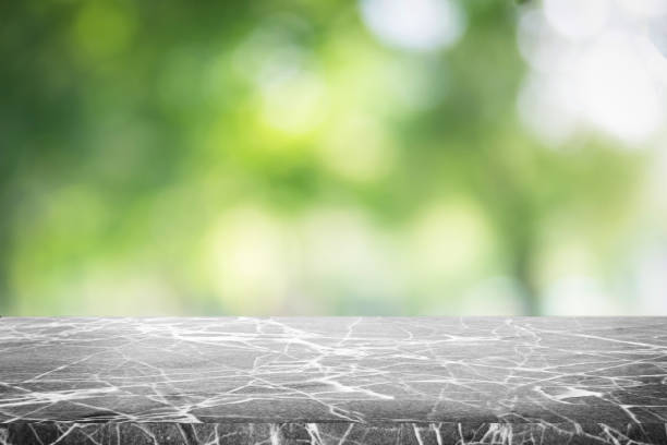 istock Gray marble stone counter top or table on backdrop blurred nature background / for display or montage your products / empty grey marble background concept. 962446346