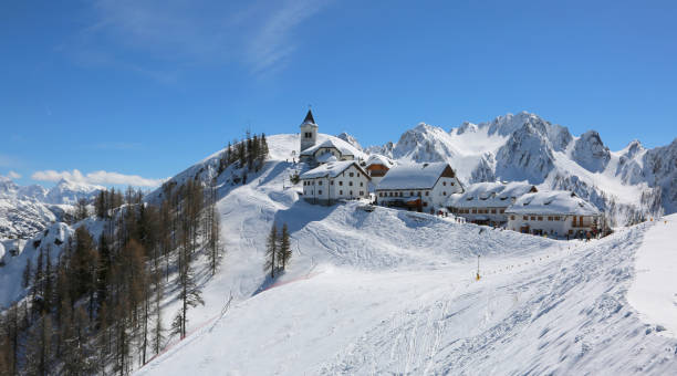 Lussari Mountain Tarvisio, UD, Italy - April 1, 2018: fabulousness panorama of the ancient Sanctuary with snow and more buildings