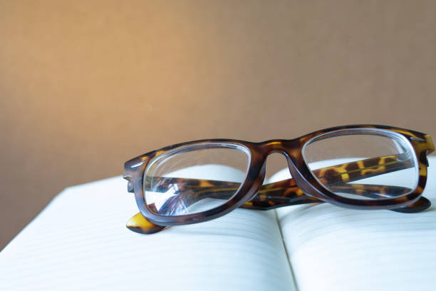 istock close up vintage glasses on blurred opened book with copy space 962452724