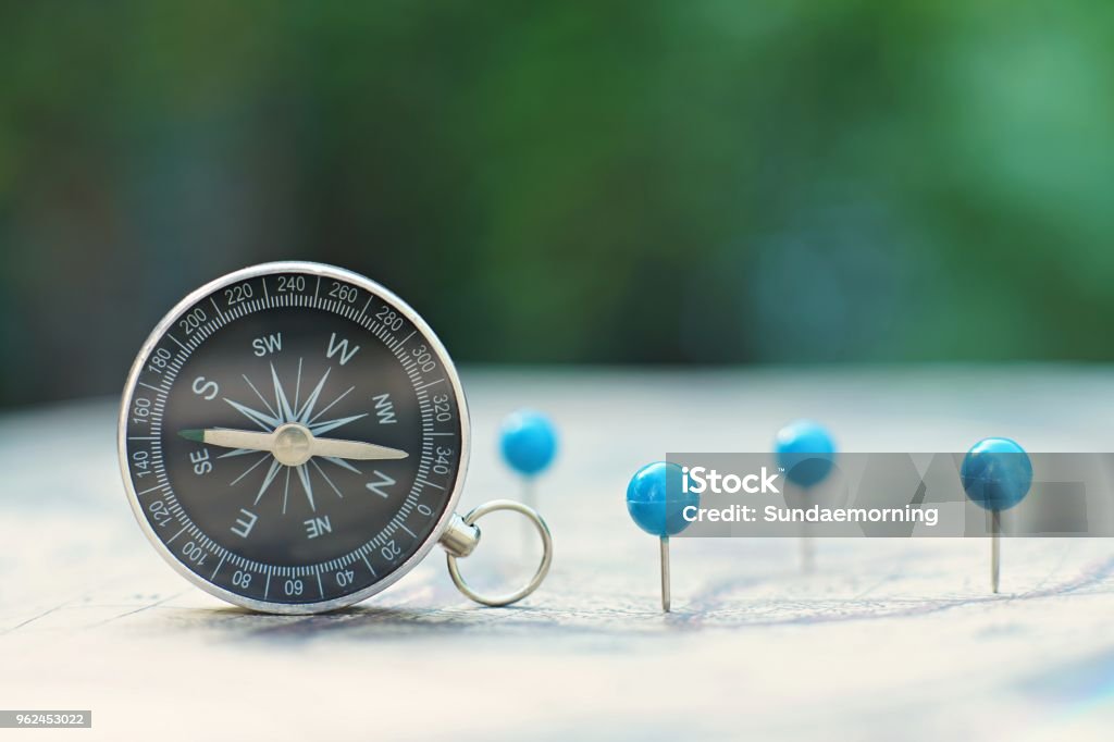 Compass and pin point marking with vintage world map background Map Stock Photo