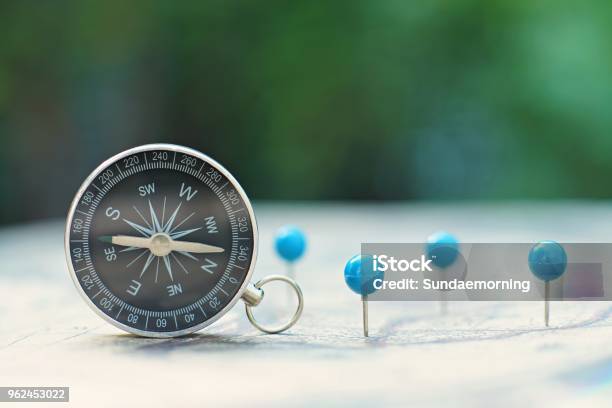 Compass And Pin Point Marking With Vintage World Map Background Stock Photo - Download Image Now