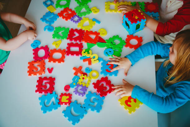 istock kids playing with number and shapes puzzle 962455248