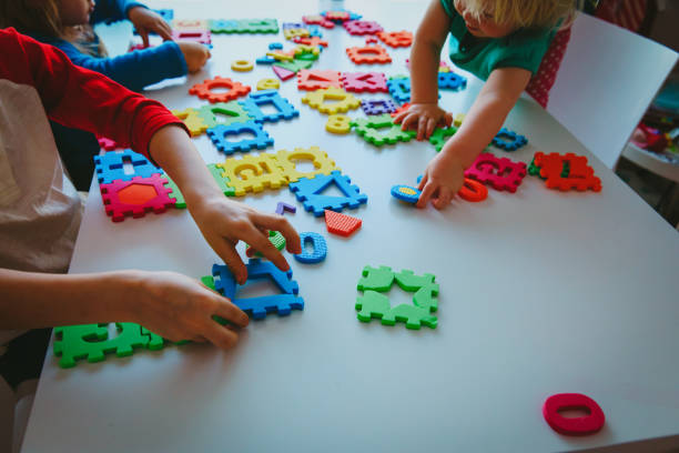 istock kids playing with number and shapes puzzle 962455294