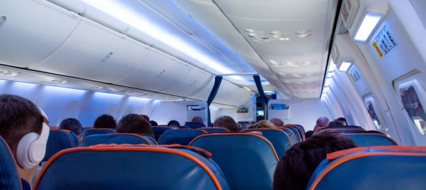 istock Cabin of aircraft with passengers on seats 962455366