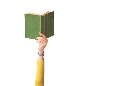 The hand holding book on isolated background