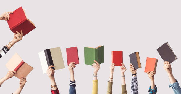 istock The hands of people hold books 962459370