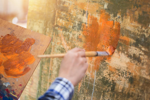 istock Asian man painting on canvas. 962459376