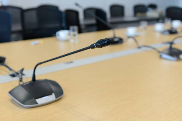 istock Selective focus conference microphones on the table in empty meeting room 962464492