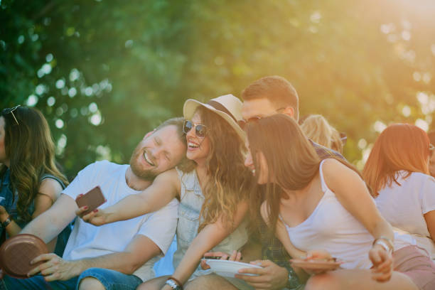 Friends sitting and taking selfie at barbecue party