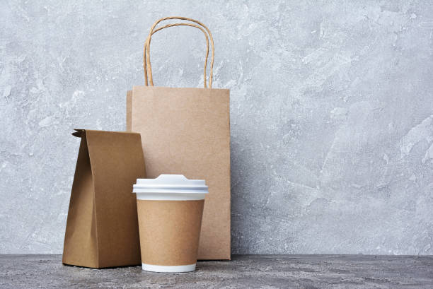 istock Take-out blank paper coffee cup with white cover, craft cup holder and brown packets 962467118