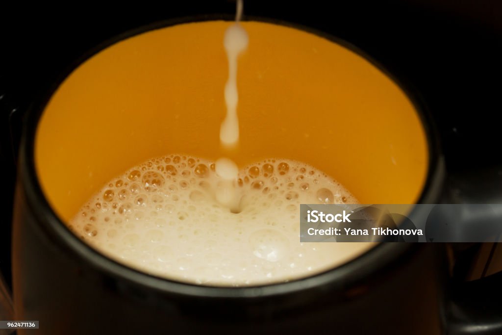 preparation of coffee with milk in the coffee machine Authority Stock Photo
