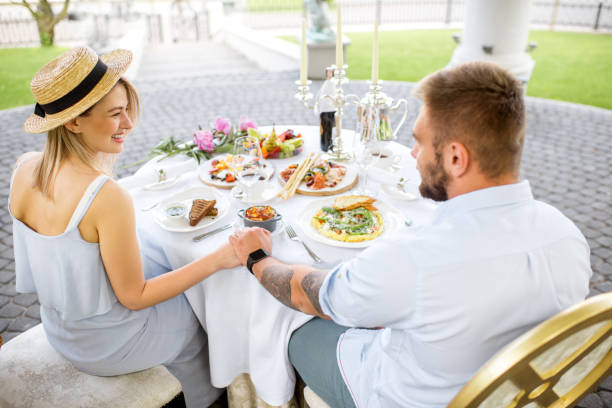 istock Young couple having romantic breakfast outdoors 962472830