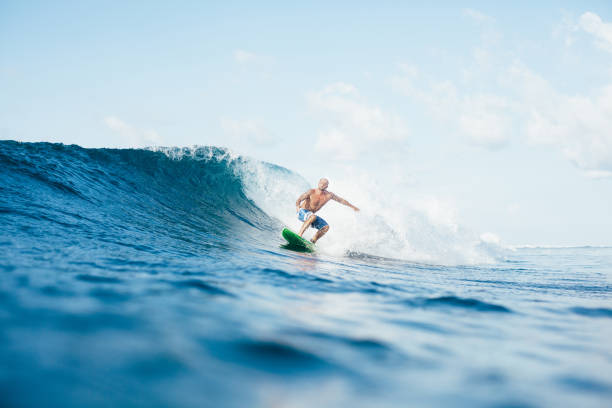 istock young sportsman having fun on surfboard on sunny day 962473248