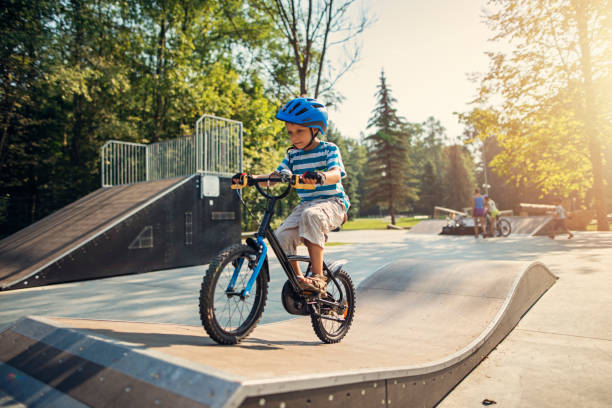 маленький мальчик верхом на велосипеде на рампе - bmx cycling bicycle cycling sport стоковые фото и изображения