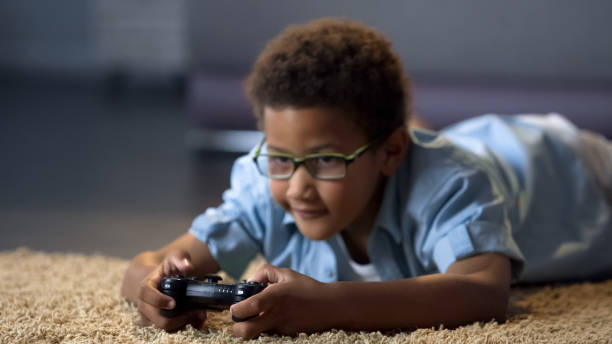 istock Boy looking at screen while playing video game, health harm, sedentary lifestyle 962478302