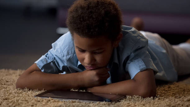 istock Child watching video on tablet, bored at home, poorly organized leisure for kid 962478342